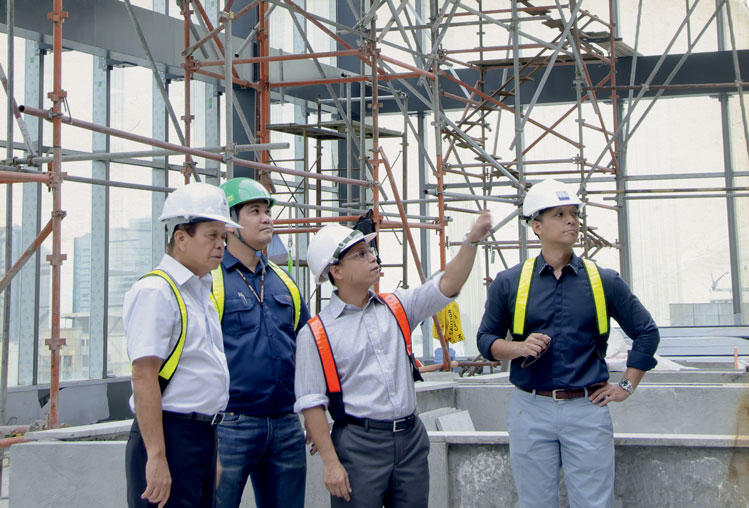 Gary, Gil and Willy Coscolluela at the Zuellig building during its construction stage, 2012