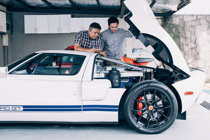 Mike Peña is a certified car lover. He admires the engine of his newest acquisition with son Paul