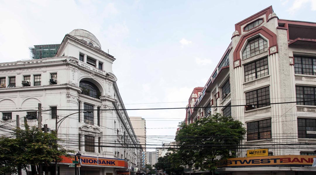 The neoclassical Regina Building (1934) and art deco First United Building (1928 — two masterpieces by Andres Luna de San Pedro, son of illustrious Filipino painter Juan Luna, stand flanking the eastern approach of Escolta Street from Plaza Santa Cruz.