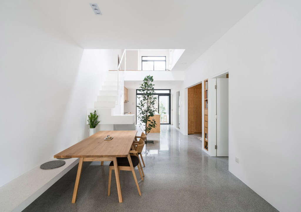 Dining area of Jose House, with white walls and concrete floors.