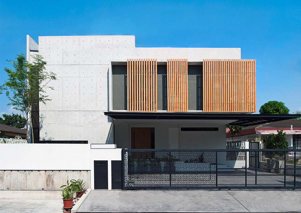 Seshan Design's modern two storey house design made of concrete and wooden accents.