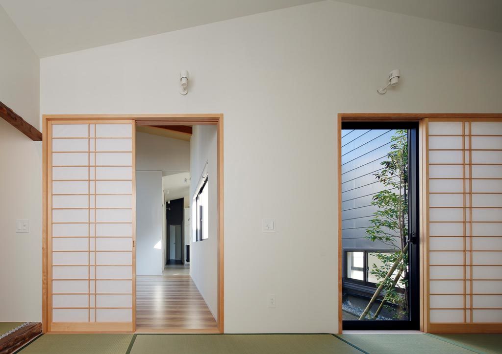 Hopscotch House with traditional shoji screens, tatami mats, and white walls.