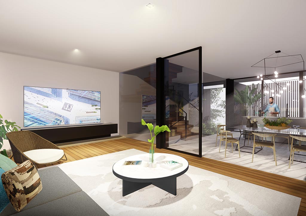 A living area with a sofa, round coffee table, and tv. A glass partition separates it from the dining room.