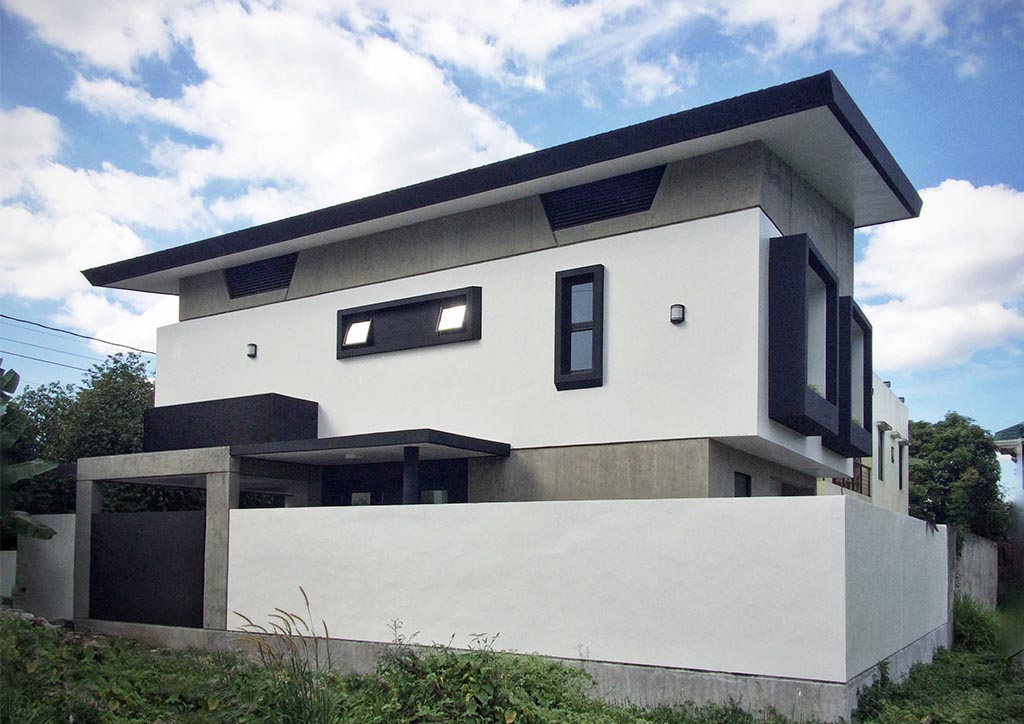 A modern bahay kubo design made of concrete and black and white color scheme.