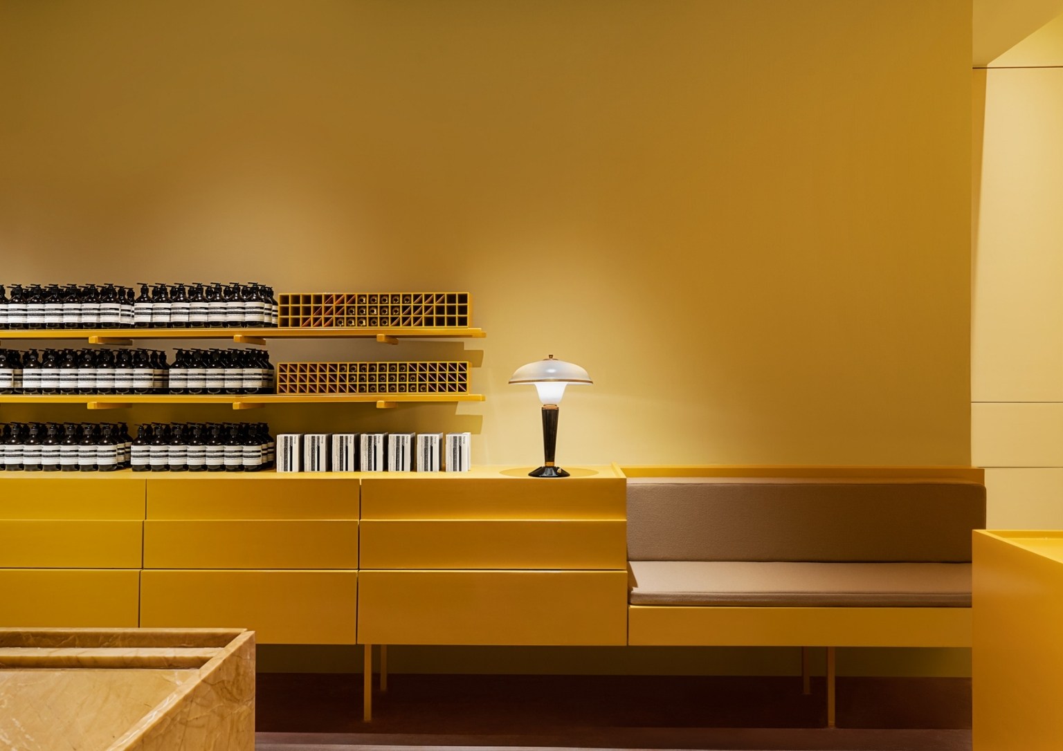 Aesop store's interior showcases their products on minimalist cabinetry.