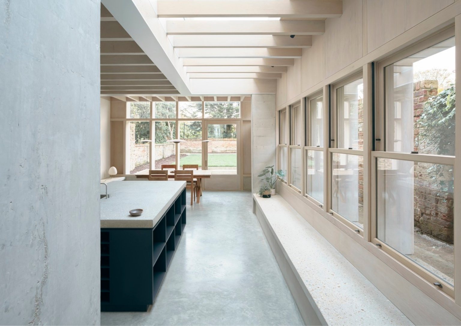 view from the entrance overlooking the modern minimalist concrete extension with a view of the backyard