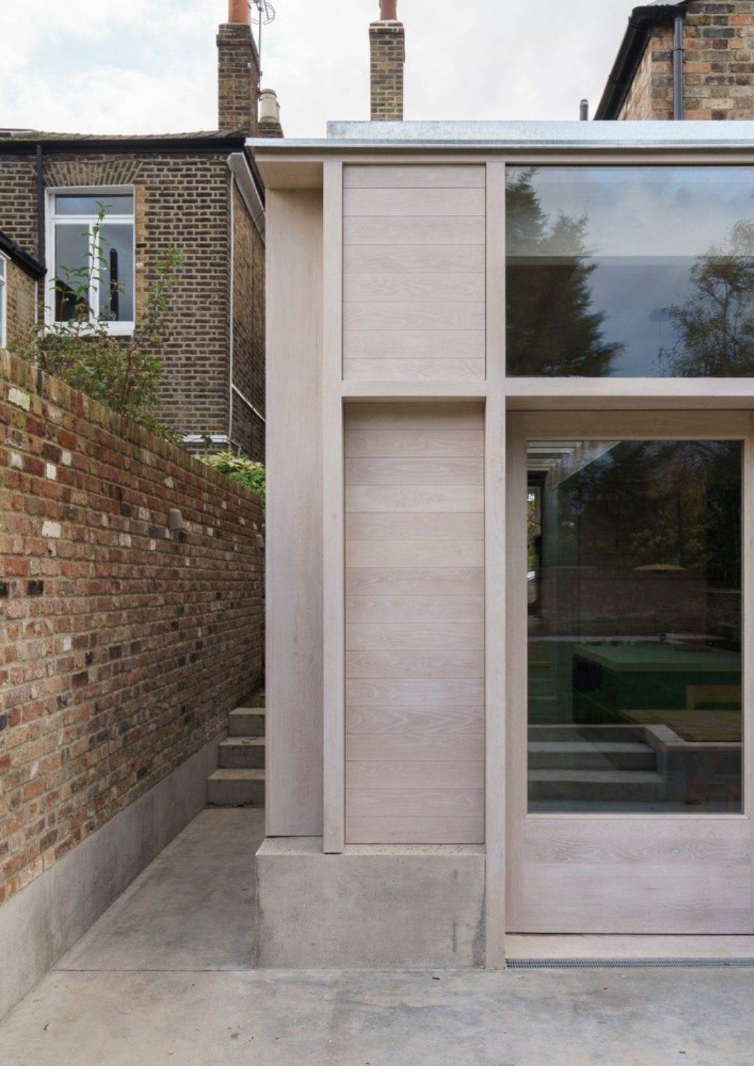 detail of home extension's light wooden exterior