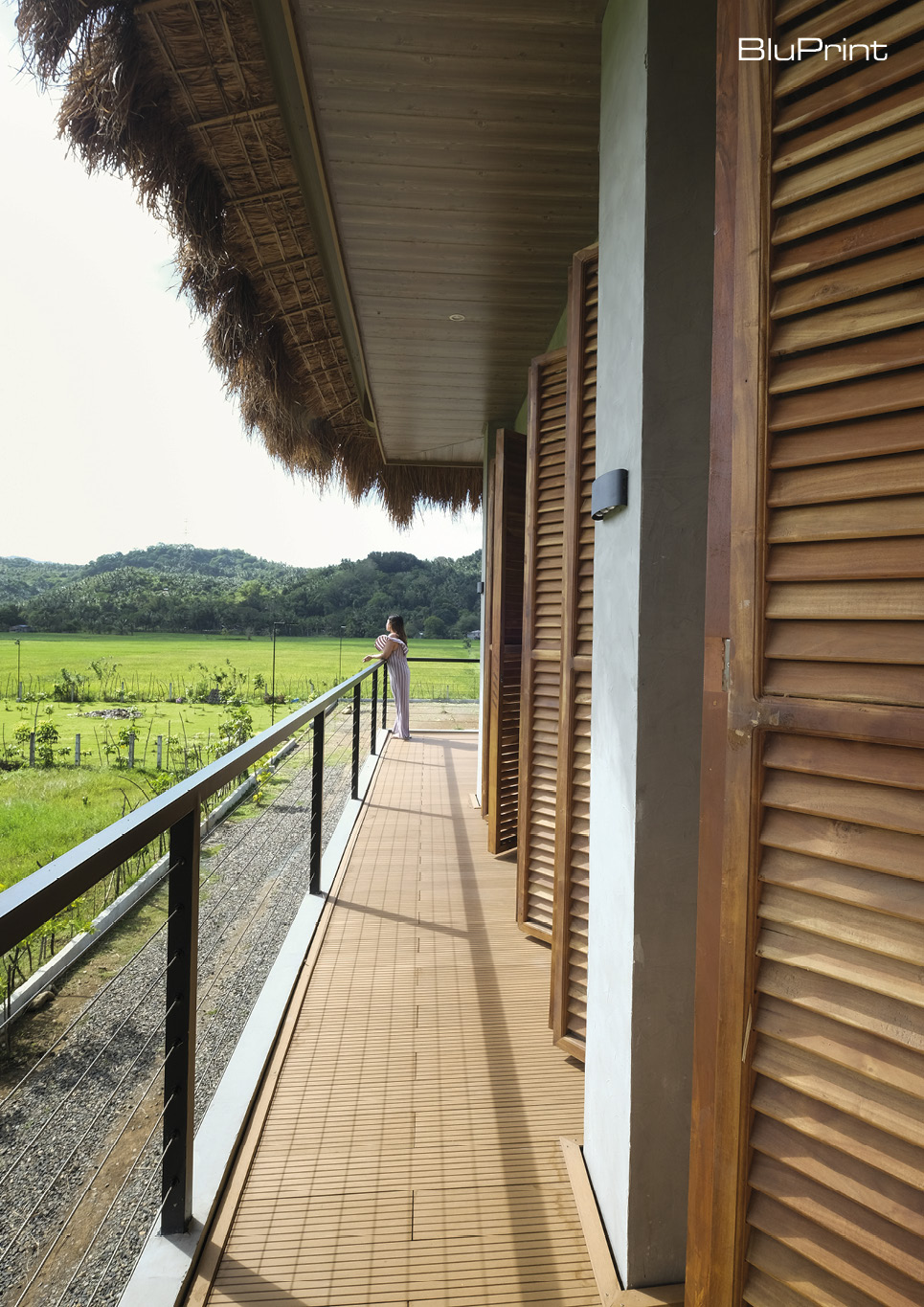 Window details of a modern bahay kubo from the wrap around balcony with views of nature.