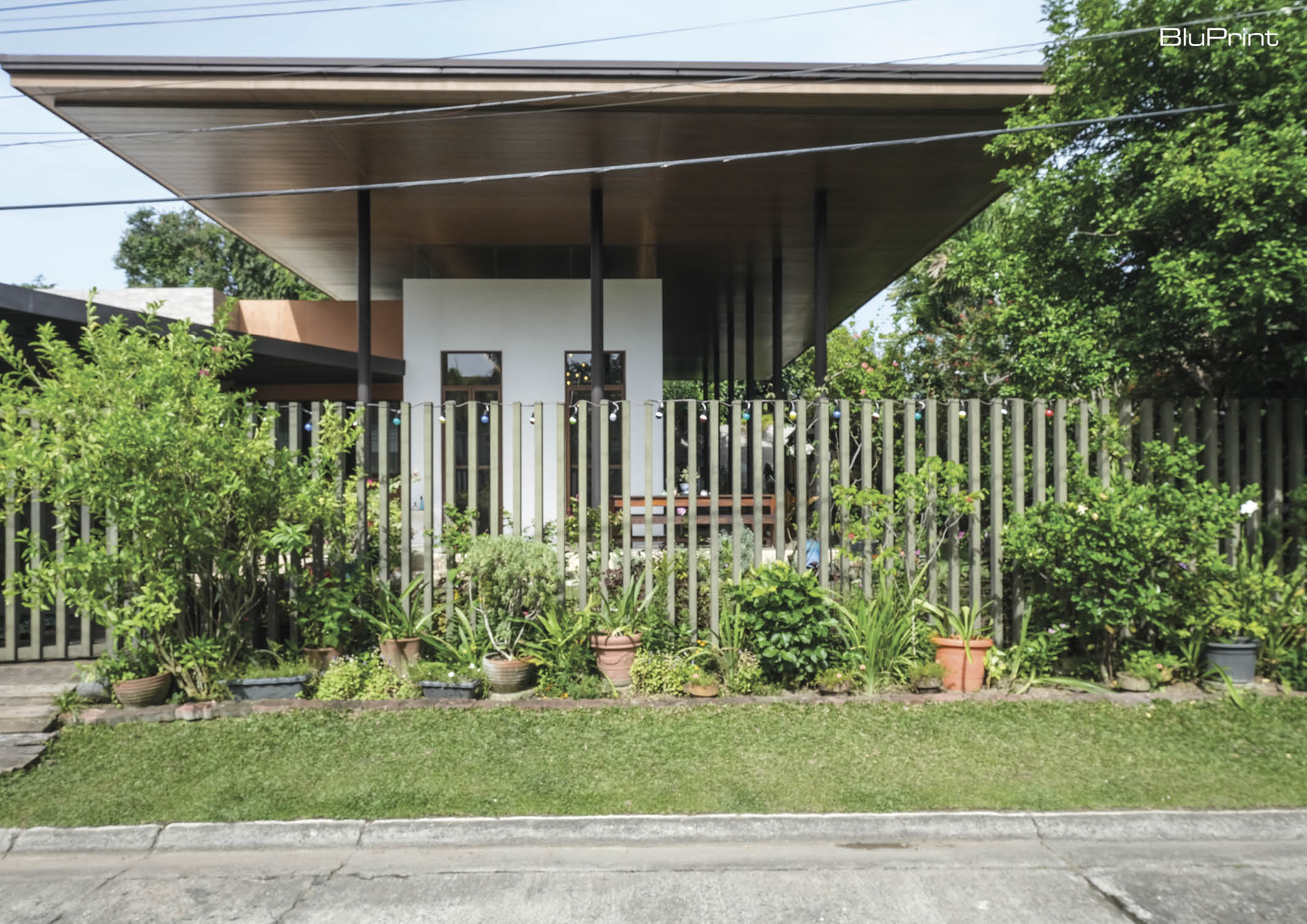 Front view of modern home's front yard and metal fencing