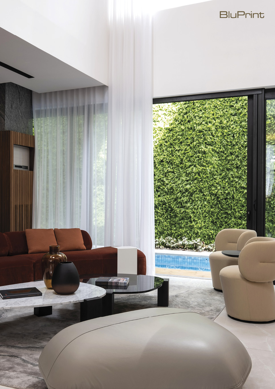 interior of modern living room overlooking a pool and greenwall