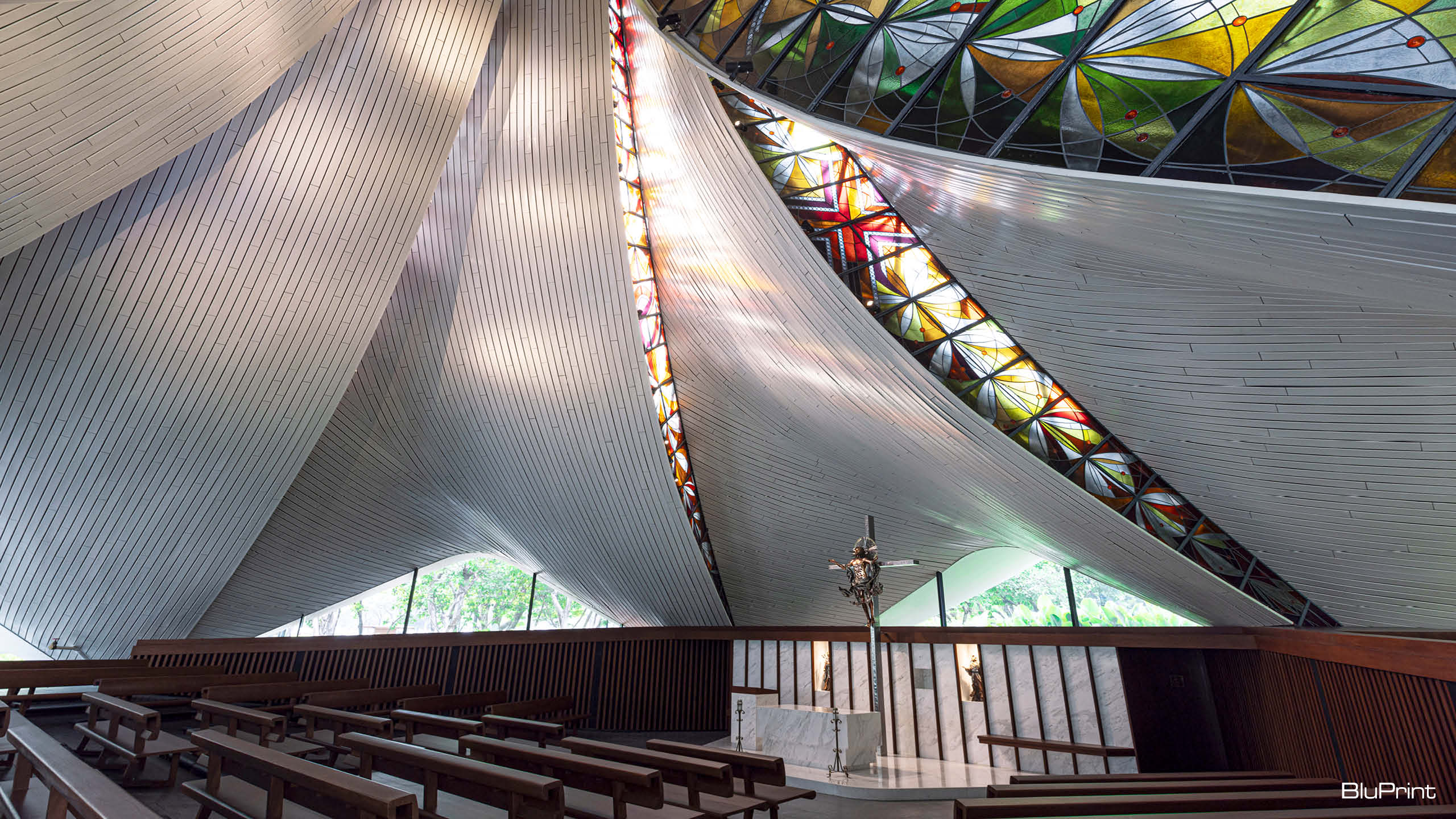 Interior shot of the Our Lady of Lourdes Chapel - ceiling and stained glass
