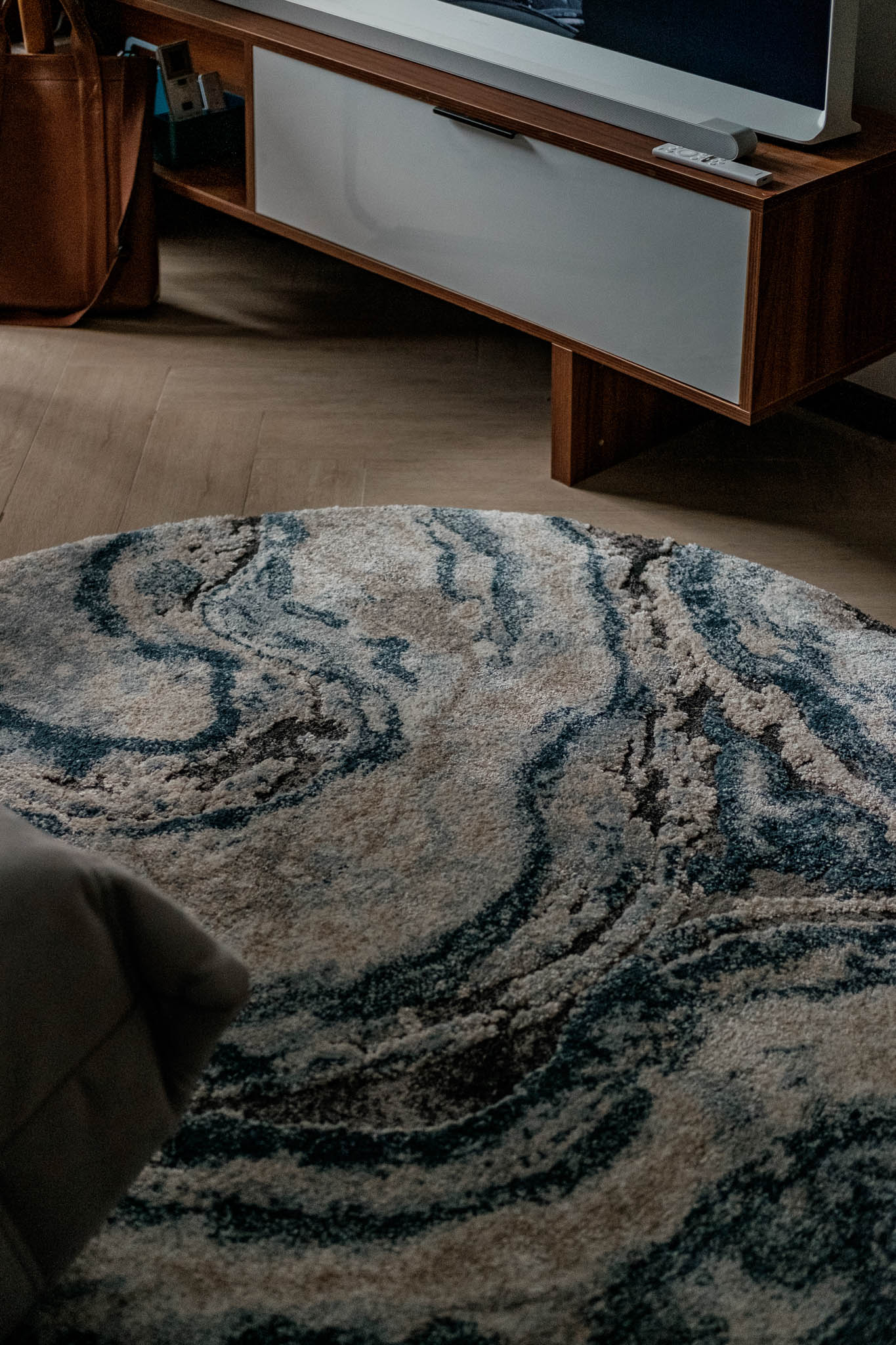 A custom marble-like rug sits at the center
