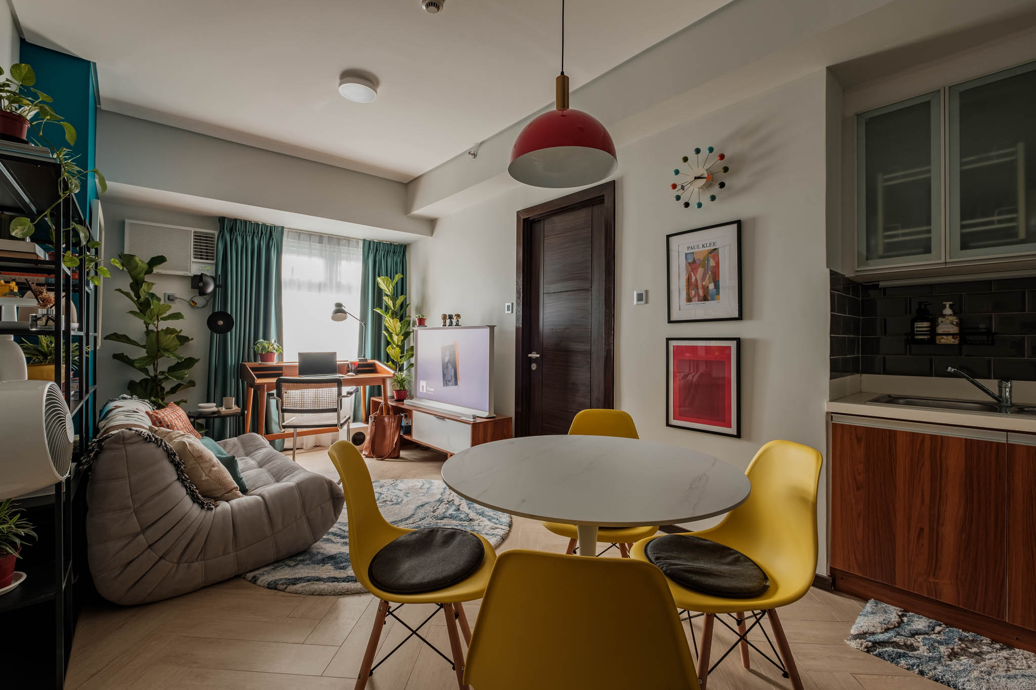 The dining area offers a welcoming first impression of the Eames-inspired yellow eggshell chair.