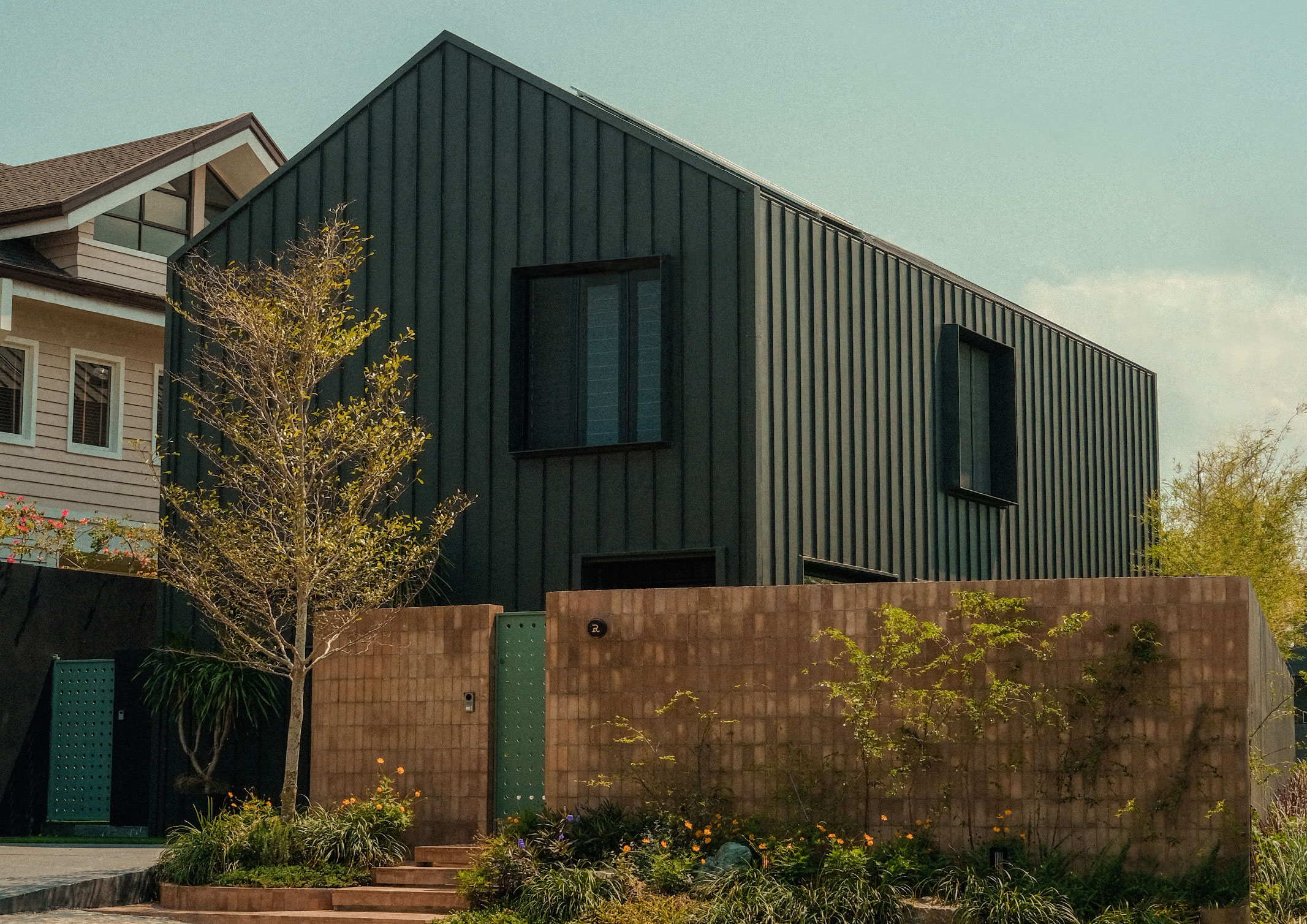 The black metal exterior of R House, a modern barn house by Hurray Design.