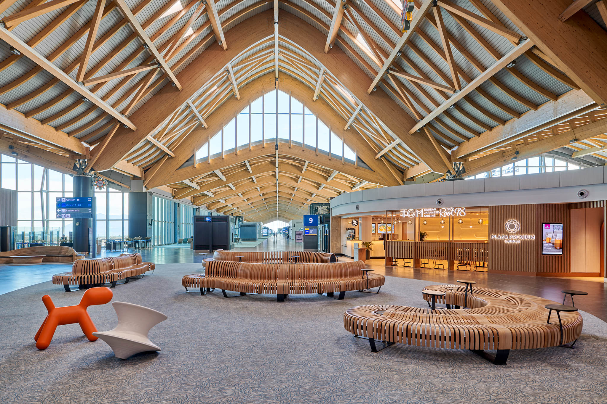 Clark Airport's commercial area with modern benches and beautiful ceiling treatment.