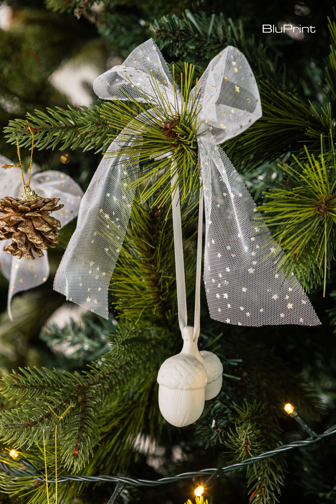 Porcelain Christmas ornaments hanging from a Christmas tree