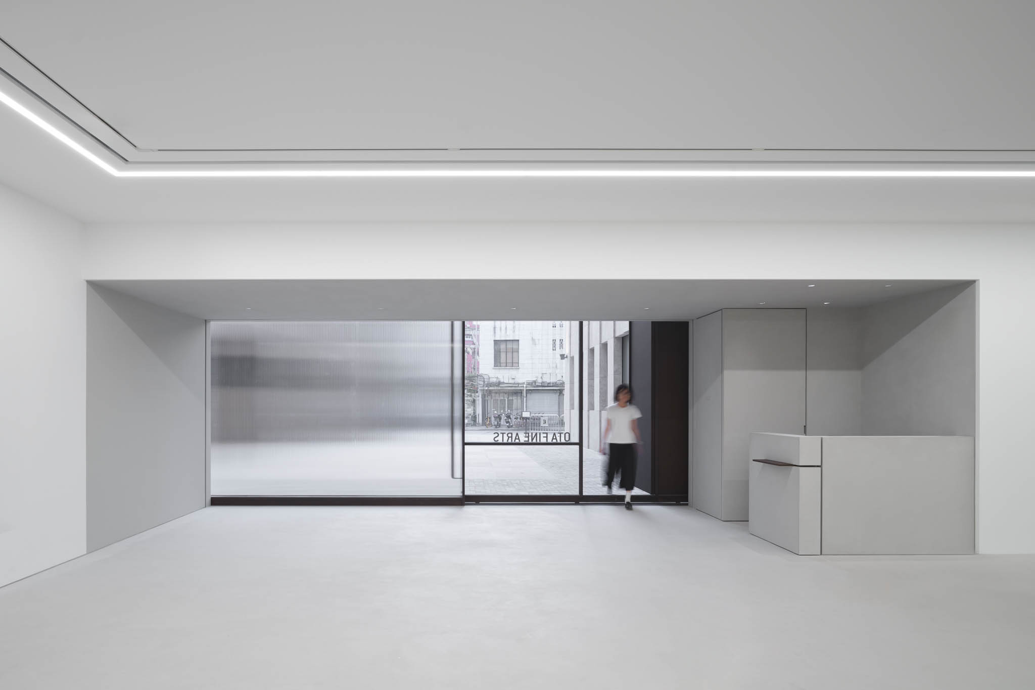 A view of the all white minimalist interior looking into the building's inner courtyard