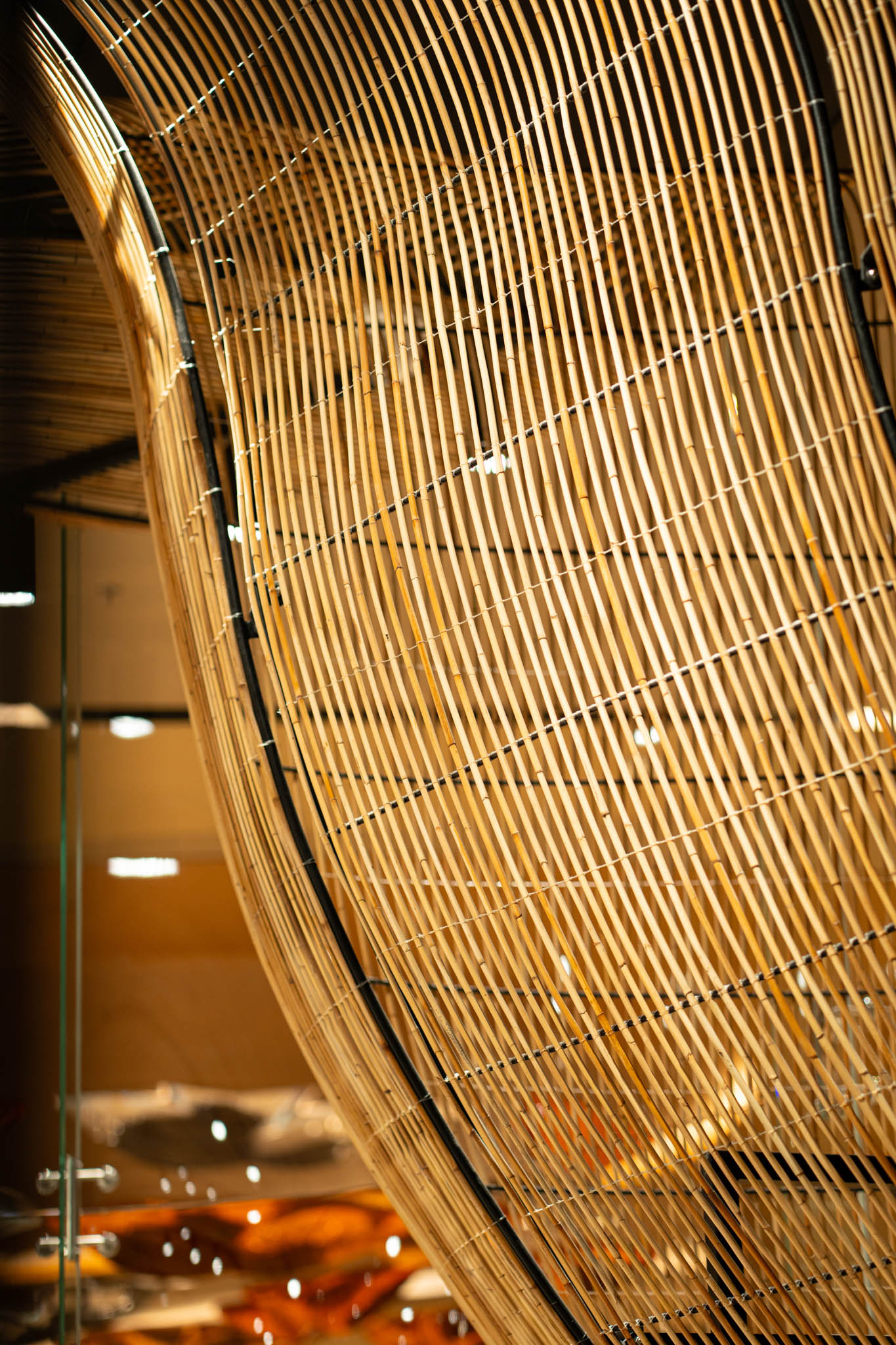 Detail of the laminated rattan installation that envelopes the retail store.