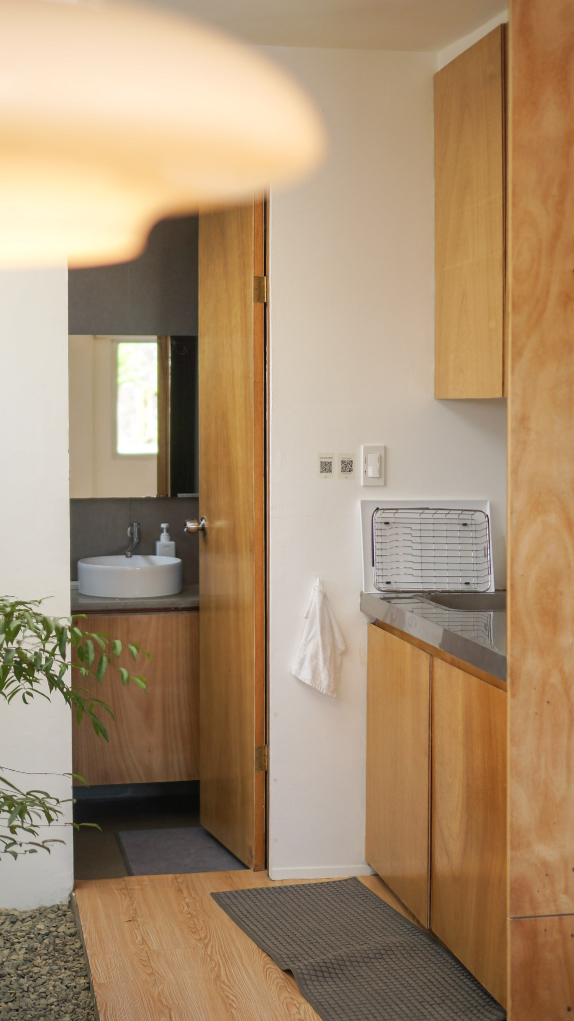 A small kitchenette next to the bathroom door revealing a small sink inside.