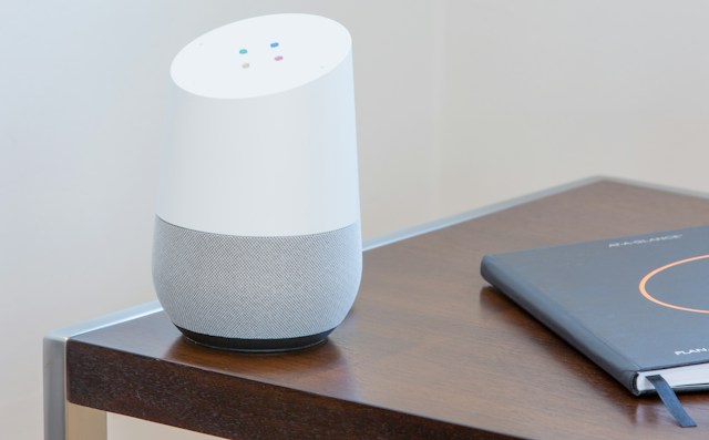 A google home unit on a table.