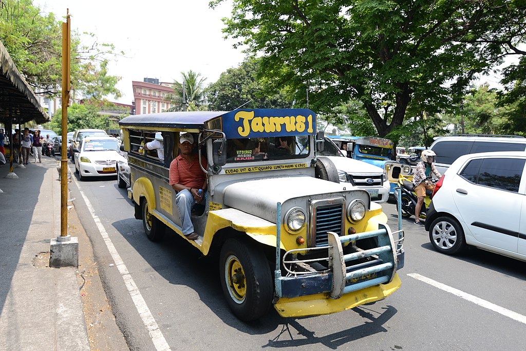 A simply designed jeepney plying the streets of manila, another potential victim of the jeepney phaseout.