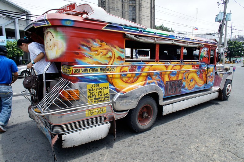 A jeepney with a fiery dragon painted on its side, another potential victim of the jeepney phaseout.