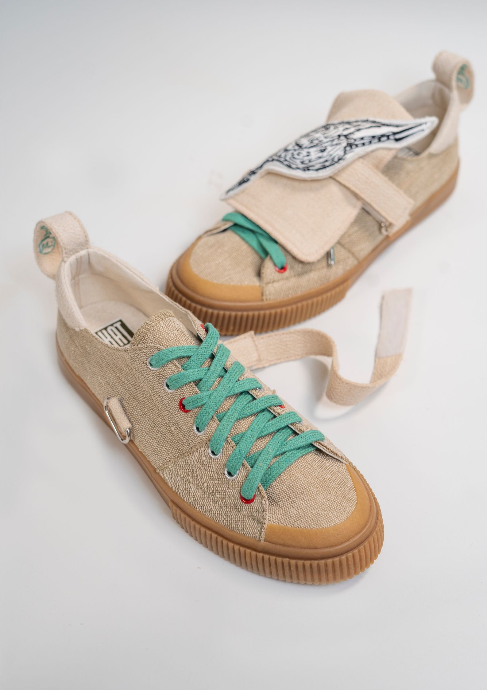 Light brown LakArt sneakers with teal laces by Lilianna Manahan.