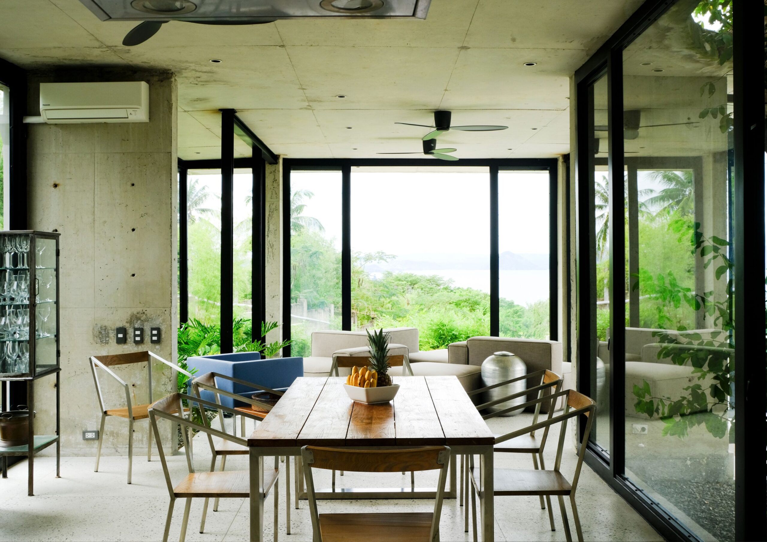 a dining and living room area with views of Taal Lake.