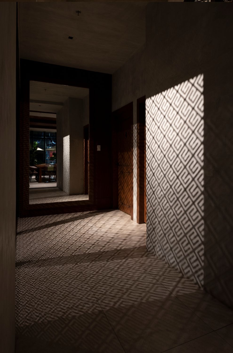 light filters through laser cut panels to create a pattern on the walls and floor at Cafe Bobs.