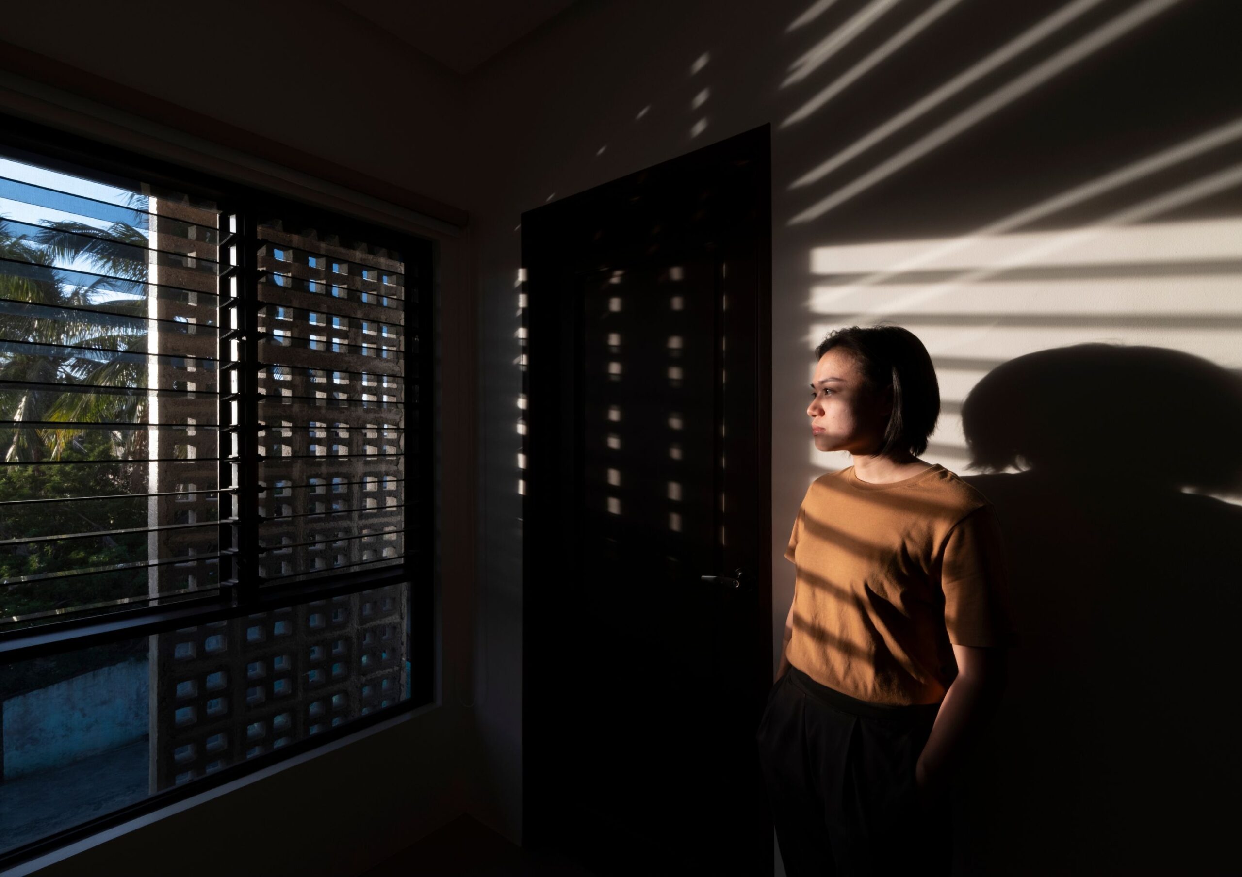 A portrait of architect Jessa San Pedro amidst a play of shadows.