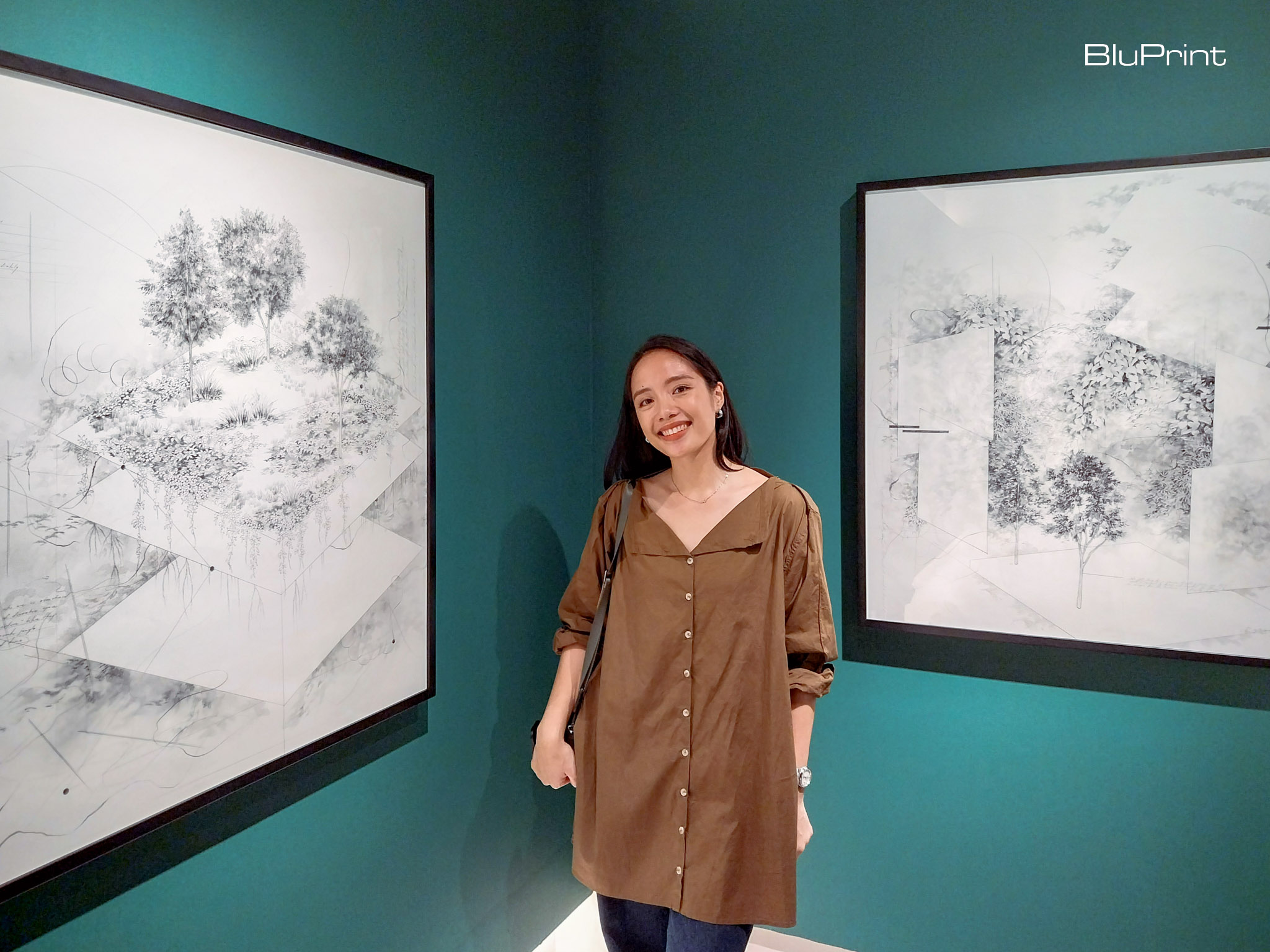 Jem Magbanua in front of two of her works at Galerie Stephanie. Photo by Elle Yap.