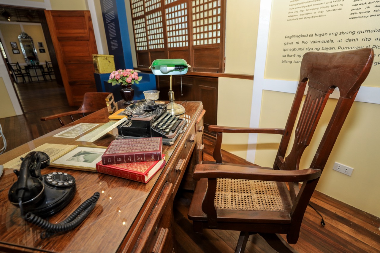 A traditional wooden desk and chair in Dr. Pio Valenzuela's bahay na bato, now a museum.