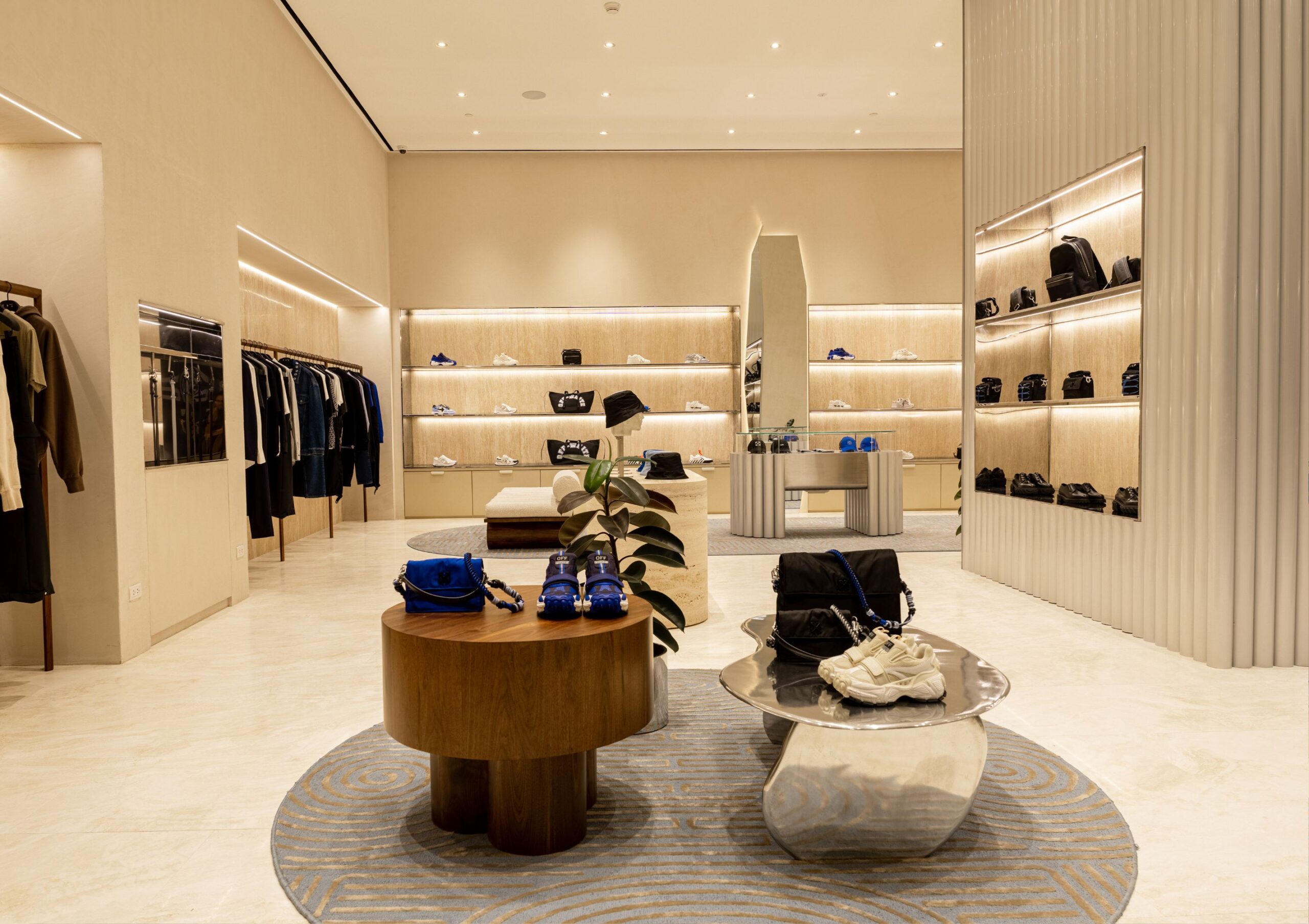 Interior of minimalist store with high end designer fashion items.