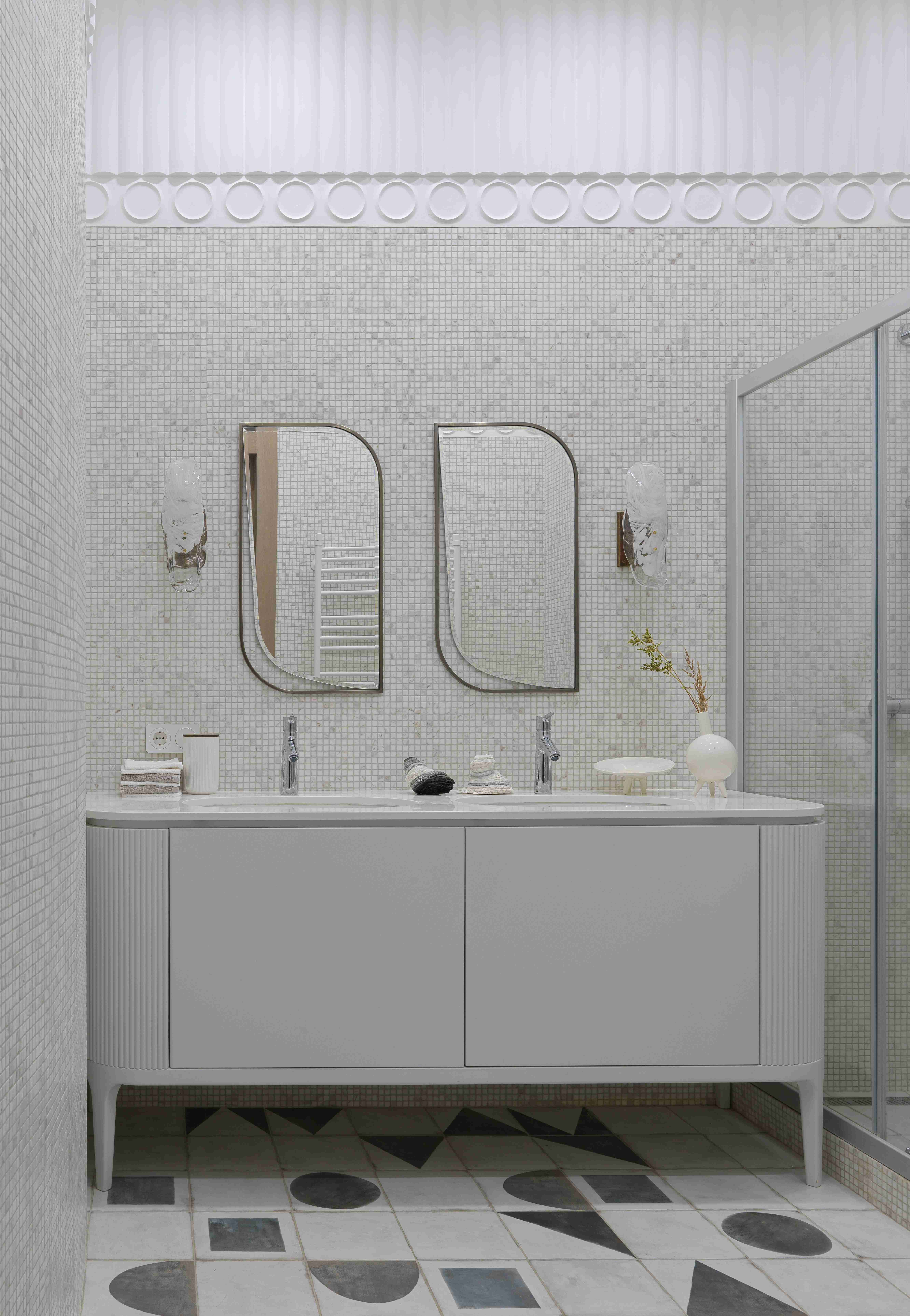 A modern white bathroom with double vanity.
