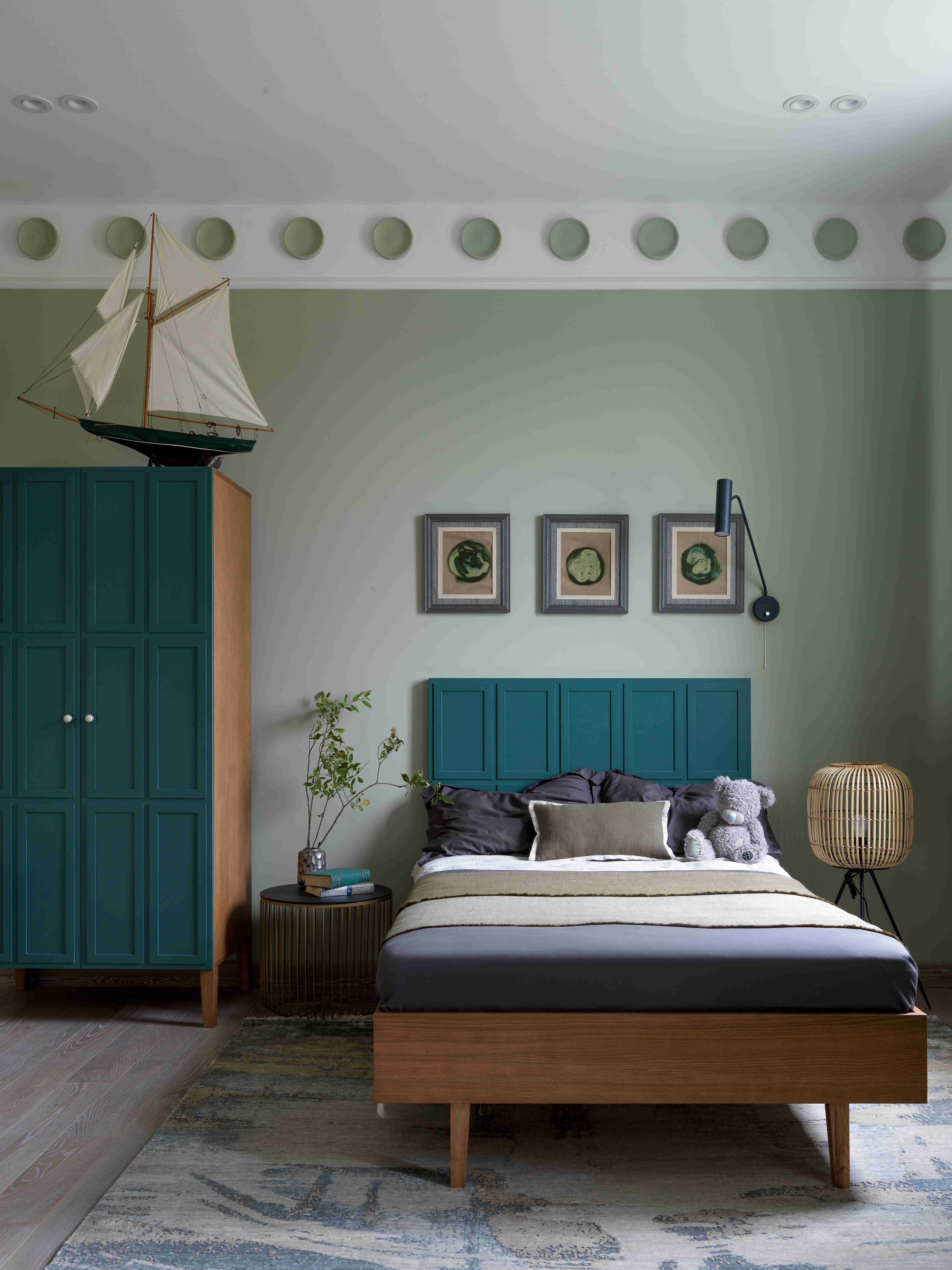 Pestovo House's bedroom with teal door and headboard, and sage green walls.