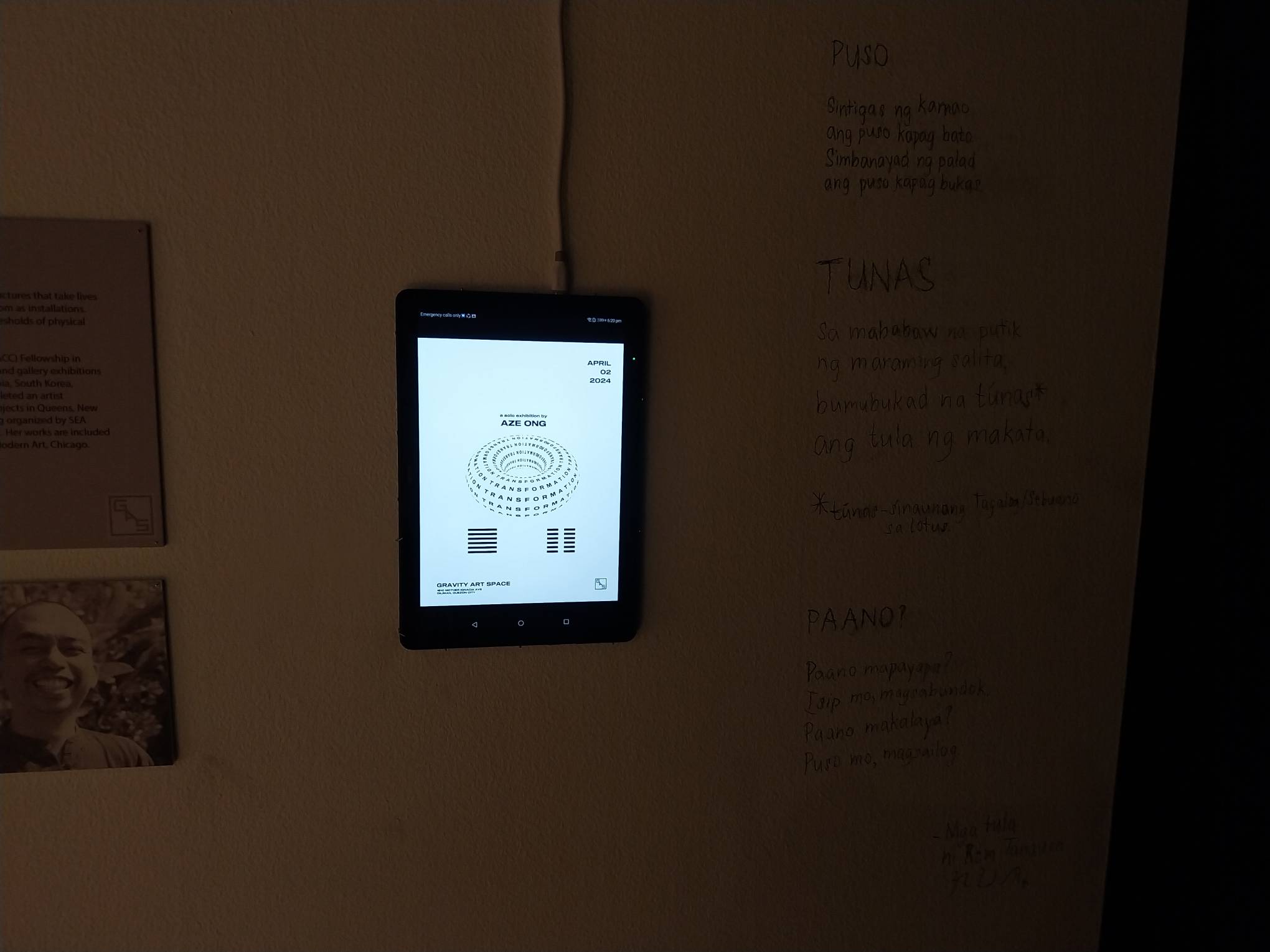 The tablet on the wall playing Ryan “Rem” Tanauan's poetry. Photo by Elle Yap.