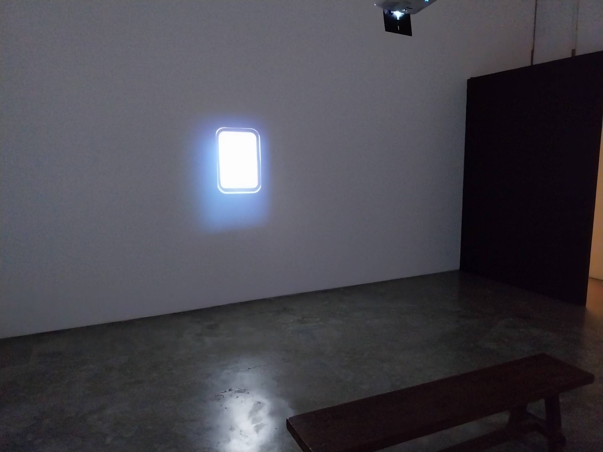 The bench where you can sit and look at a simulation of a window. Photo by Elle Yap.
