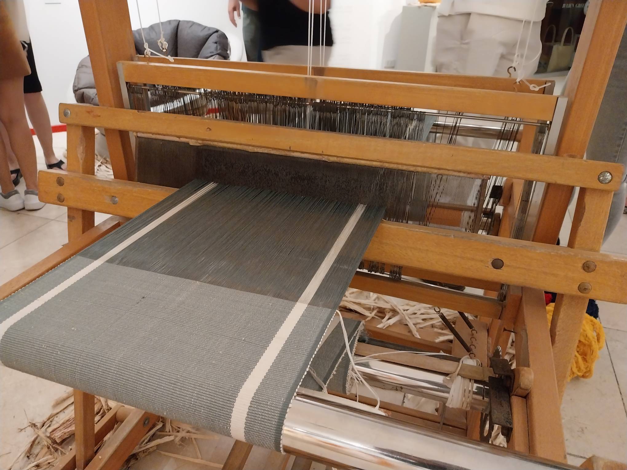 Large weaving loom with fabric on the machine. Photo by Elle Yap.