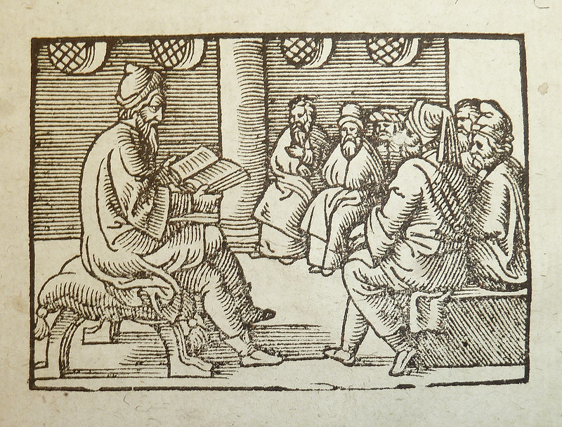 A woodcut illustration of a teacher and their students. Photo by POP. Source: Flickr.