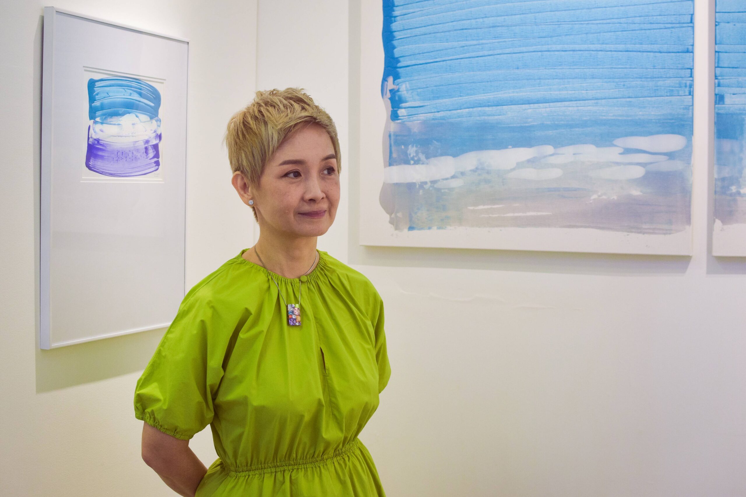 Artist Janice Liuson-Young photographed in front of her paintings. Photo courtesy of Patrick de Veyra. 