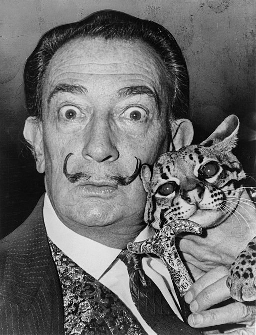 Salvador Dali with a cat. Photo by Roger Higgins. Source: Wikimedia Commons.