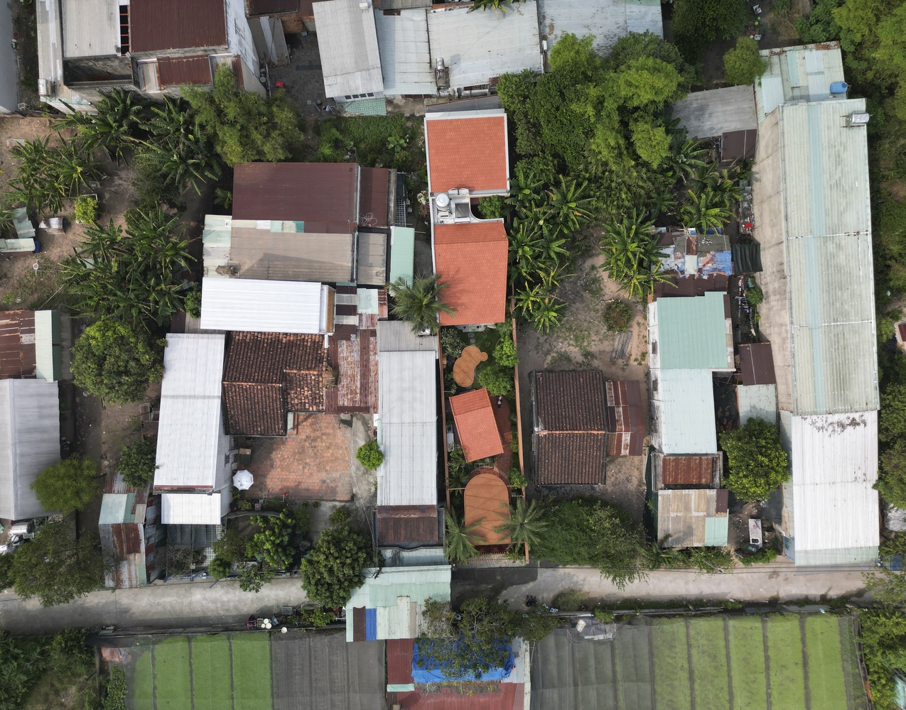 An aerial view of Nam Sua House and its unique undulating metal roof.