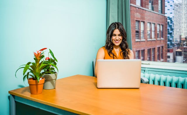 Person with office plant. Photo by Jopwell. Source: Pexels.