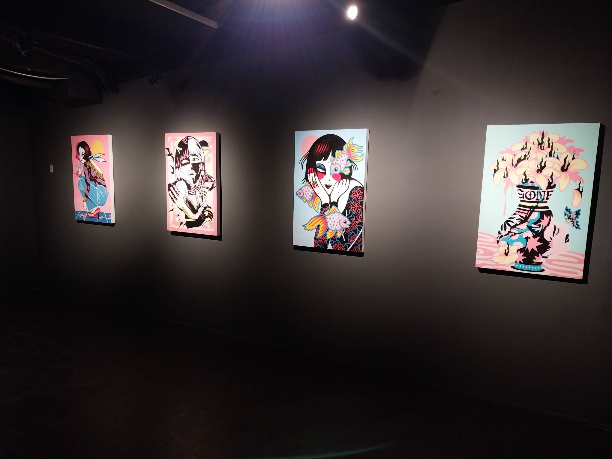 Some of the paintings featured for "Misery Loves Company." Photo by Elle Yap.
