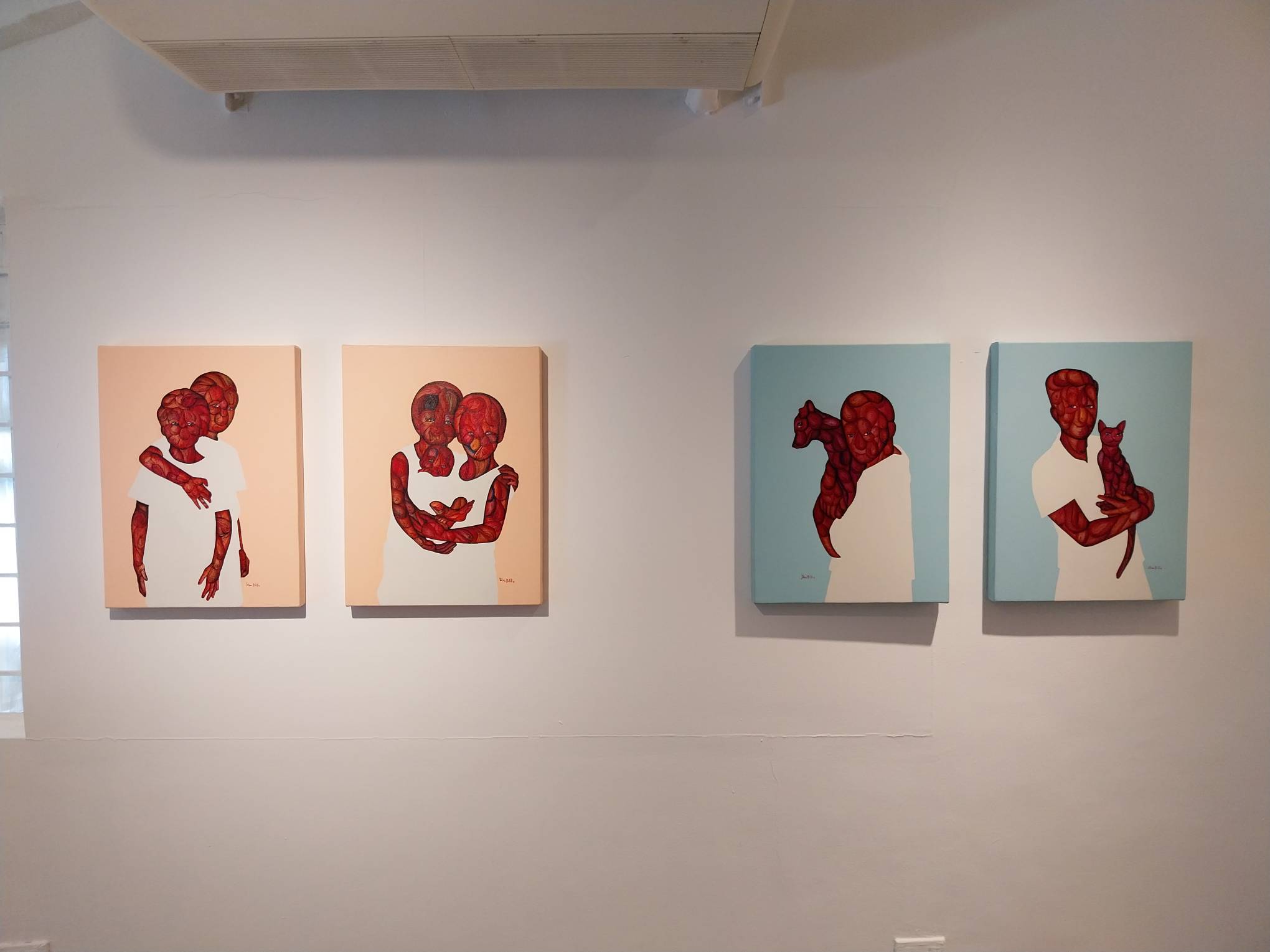 Four paintings by Julius Redillas for "Word on the Street." Photo by Elle Yap.
