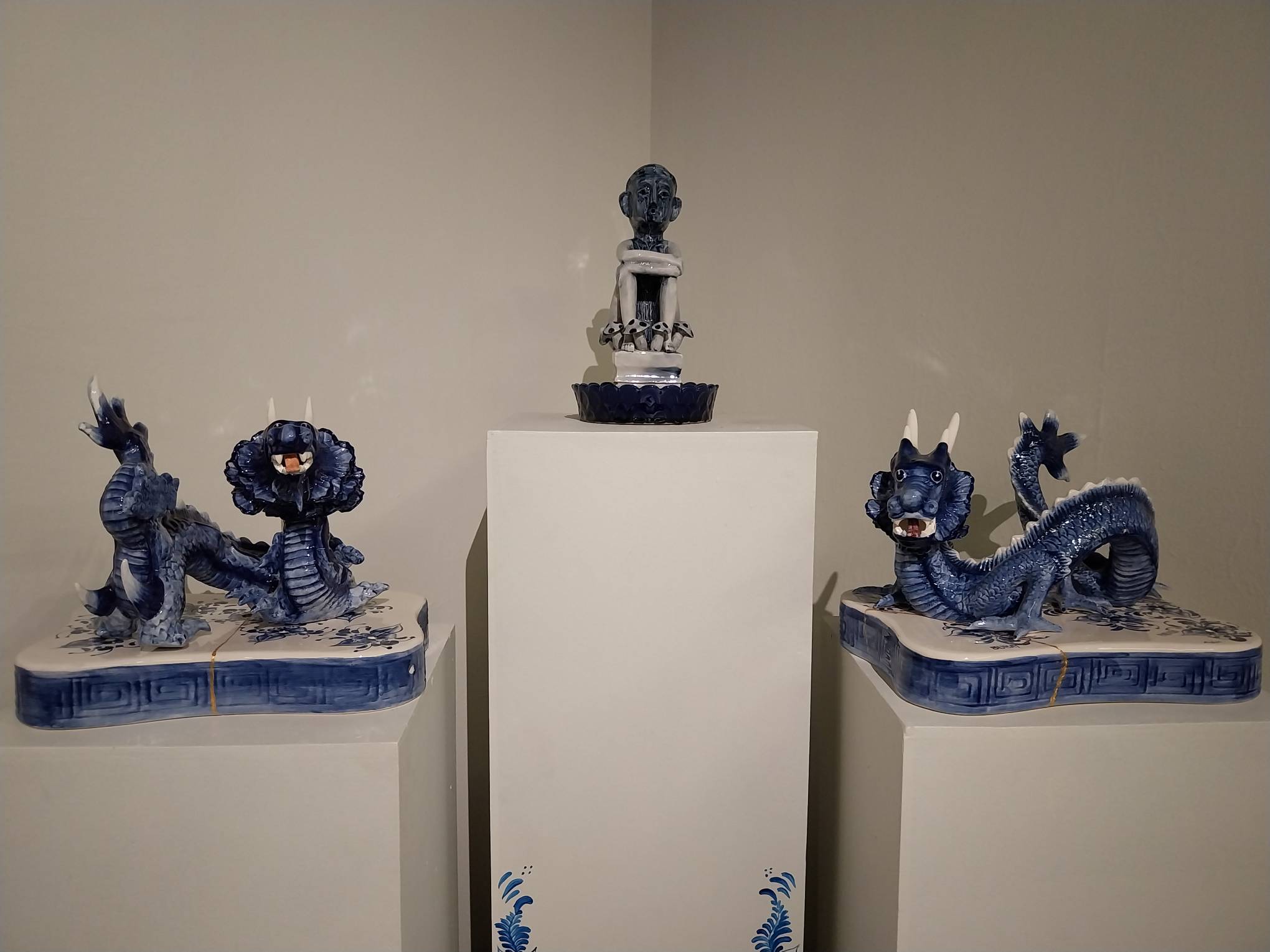 Three porcelain sculptures as presented in the exhibit. Photo by Elle Yap.