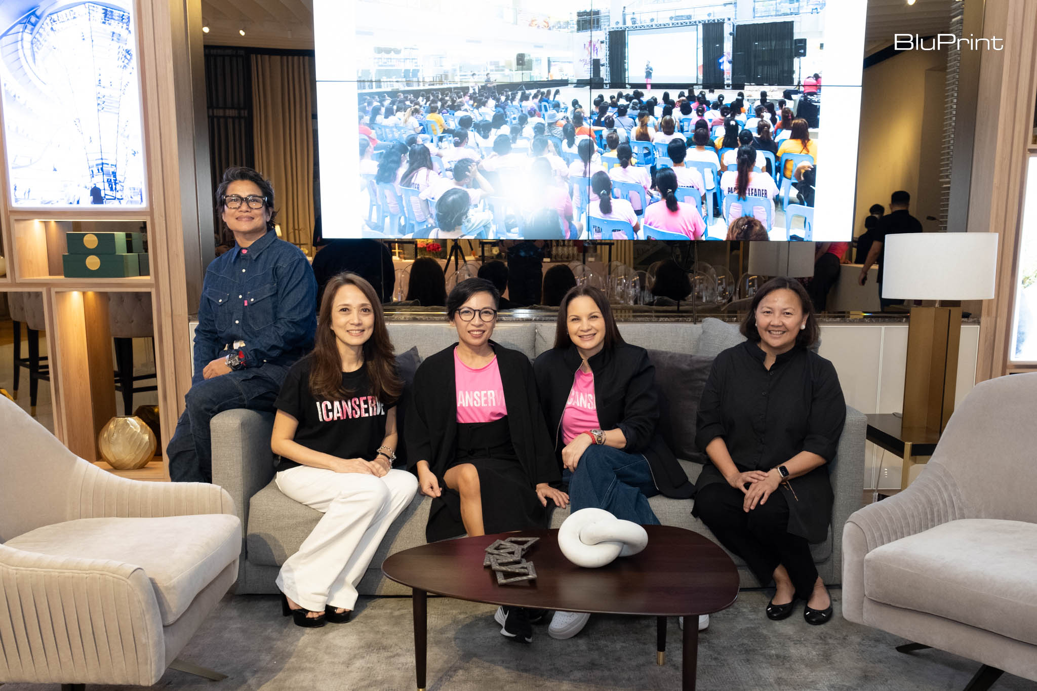 Proponents of the Pink Room sitting on a sofa.