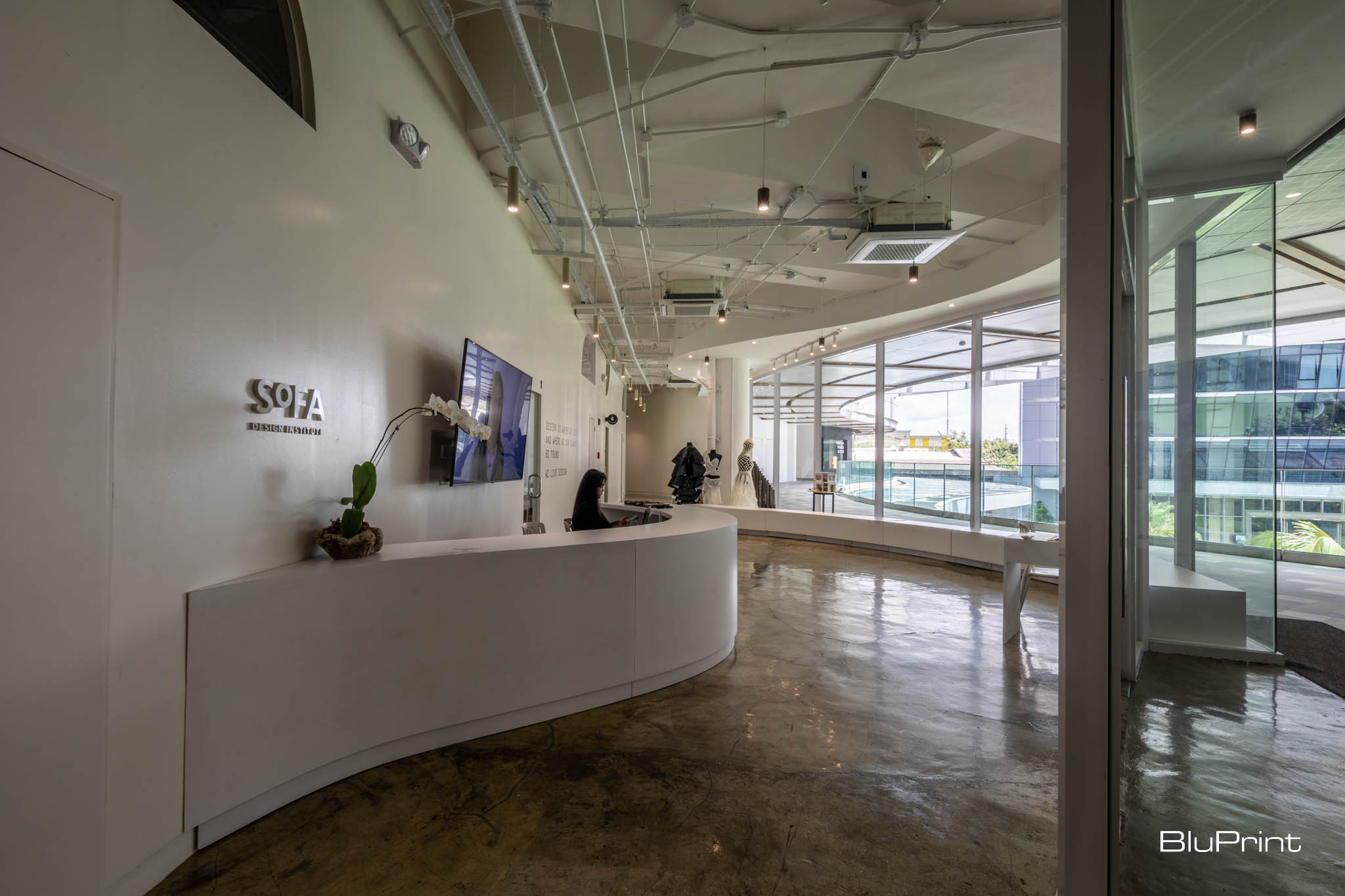 SoFA Design Institute lobby with curved walls and reception desk.