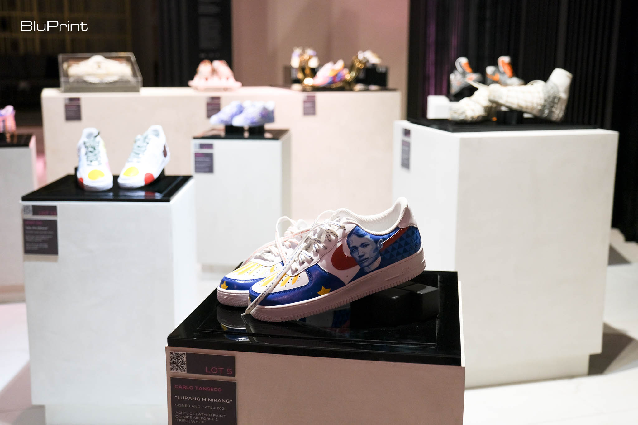 Display of sneakers designed for The Pink Room: Gallery for Good.