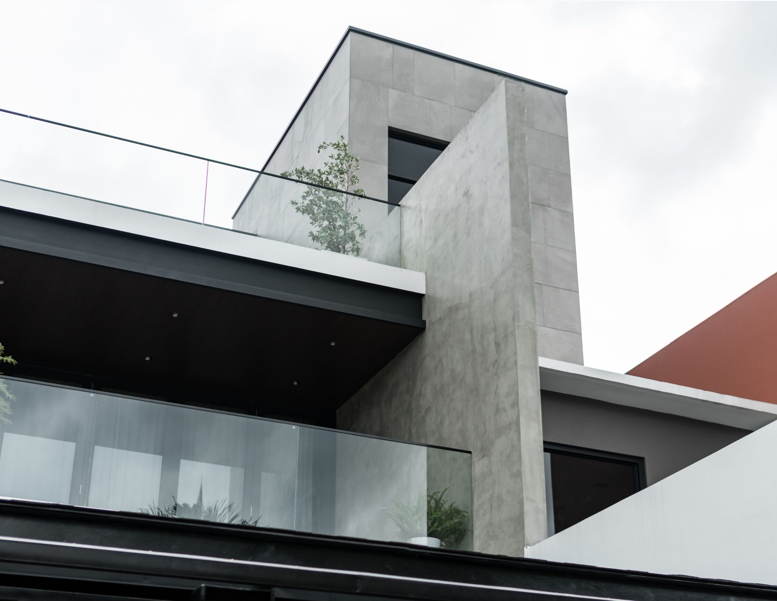 A tasteful combination of concrete, glass, and metal makes up V House's exterior.